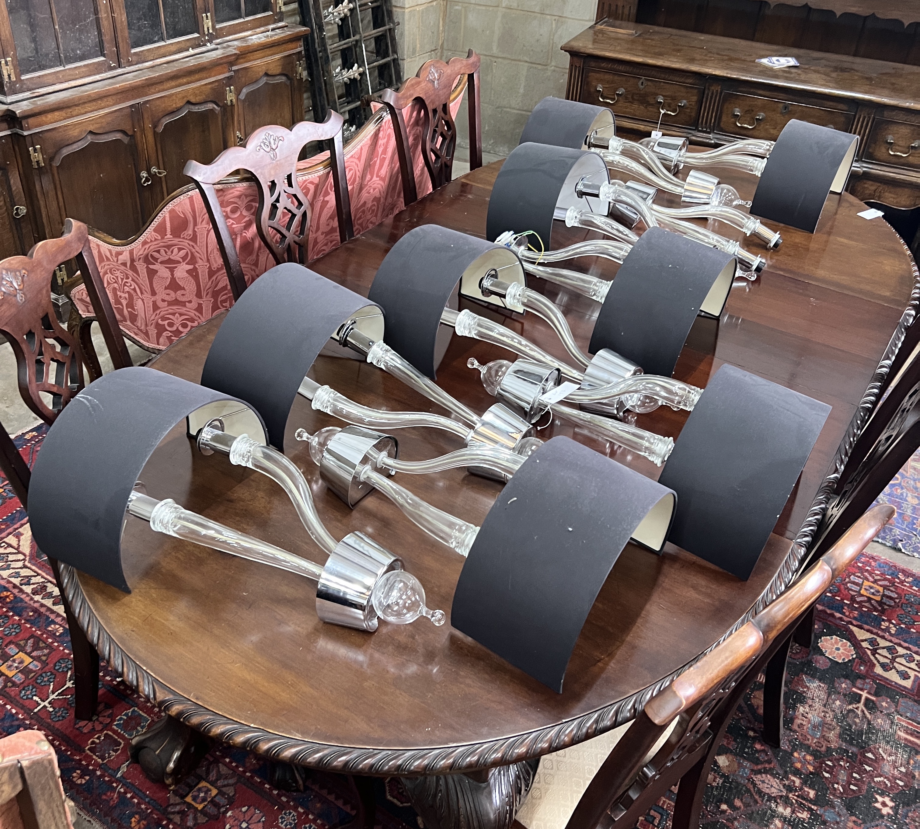 A set of ten contemporary glass and chrome two branch wall lights